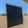 Portable Plyo Mat hanging on a fence